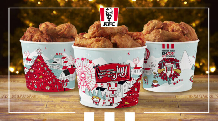 With the holidays just around the corner, Kentucky Fried Chicken® is serving up extra joy this season with a new holiday bucket design and matching holiday merch collection. The famous fried-chicken chain is also serving up two new menu items to make holiday celebrations Extra Crispy™. (PRNewsfoto/Kentucky Fried Chicken)