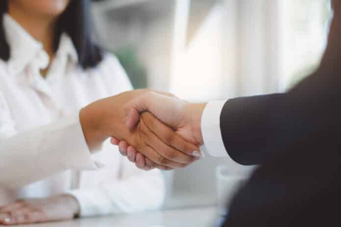 two business people shaking hands after contract is done.